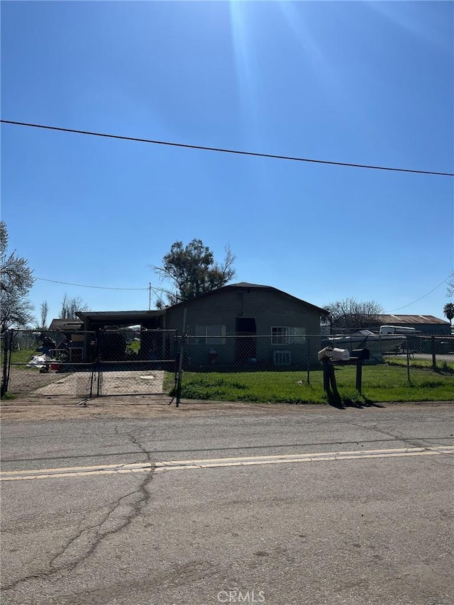 view of front of home with a fenced front yard and an attached carport