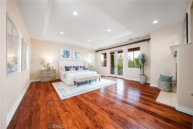 113 Tearose, Irvine, CA 92603 - bedroom featuring a tray ceiling, access to exterior, baseboards, and wood-type flooring