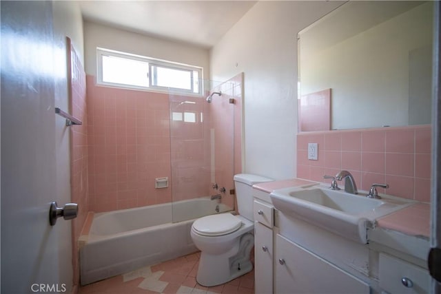 full bathroom with toilet, tile walls, tub / shower combination, decorative backsplash, and vanity