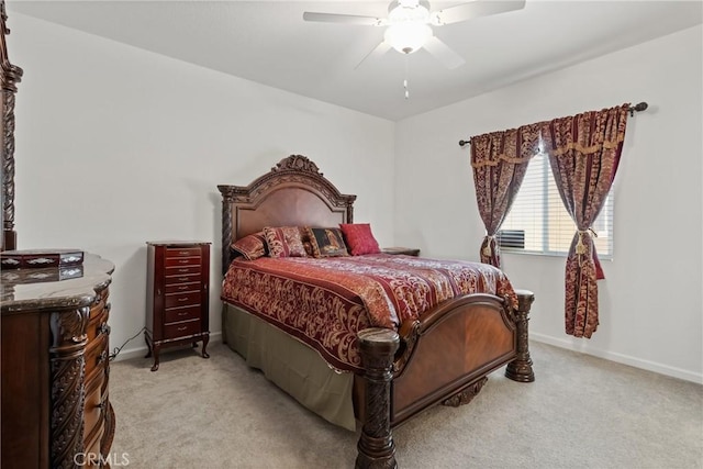 bedroom with a ceiling fan, light colored carpet, and baseboards