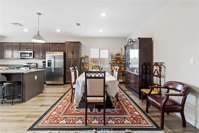 dining space featuring recessed lighting, visible vents, and light wood finished floors