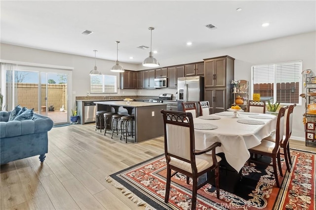 dining area with visible vents, recessed lighting, and light wood-style floors