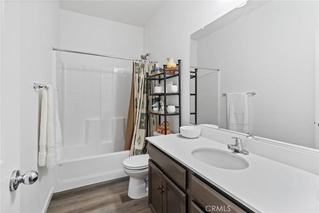 full bathroom with shower / bathtub combination with curtain, toilet, wood finished floors, and vanity