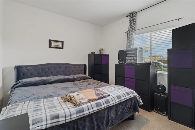 bedroom featuring light carpet