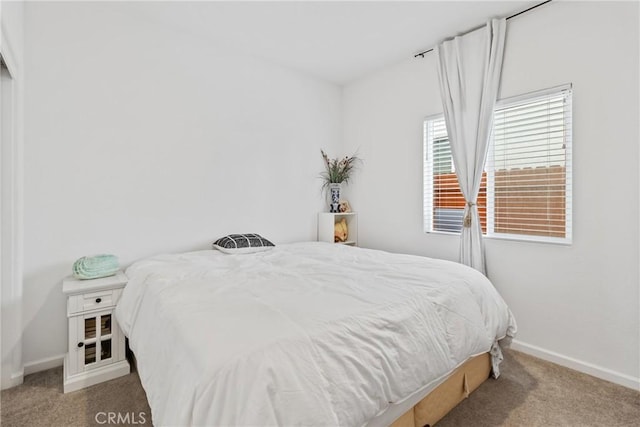 carpeted bedroom featuring baseboards