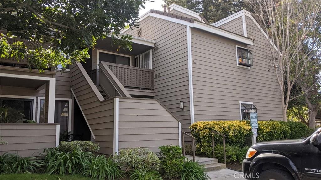 view of side of property featuring a balcony