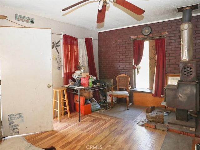 3586 Halika St, Clearlake, CA 95422 - interior space featuring a wood stove, wood finished floors, and ceiling fan