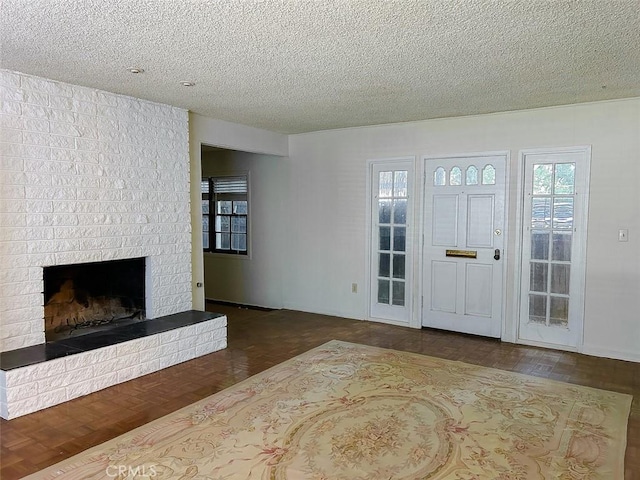 entryway featuring a textured ceiling and a fireplace