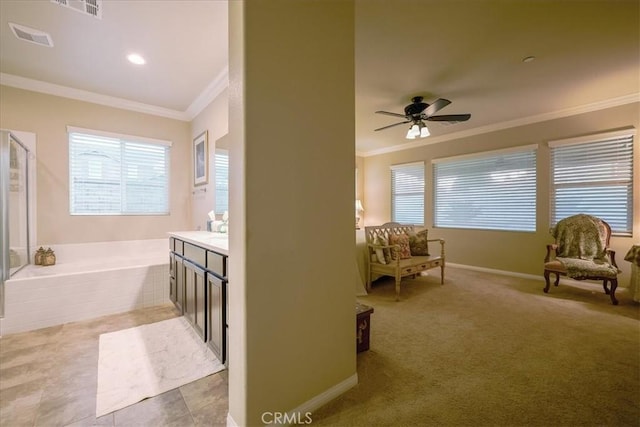 full bathroom featuring crown molding, a ceiling fan, visible vents, and a garden tub