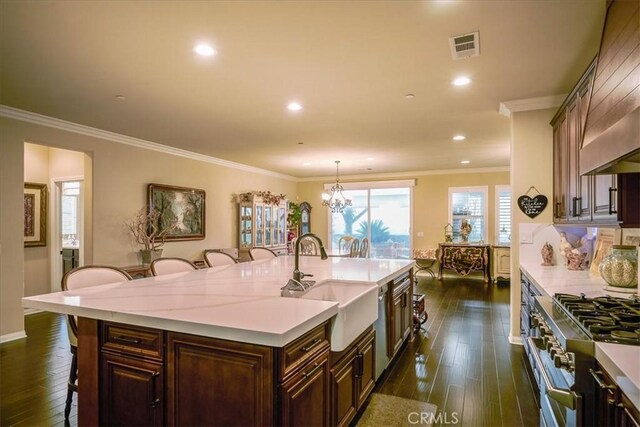 30459 Cowboy Ln, Menifee, CA 92584 - kitchen featuring a sink, a breakfast bar, high end stainless steel range oven, light countertops, and ornamental molding