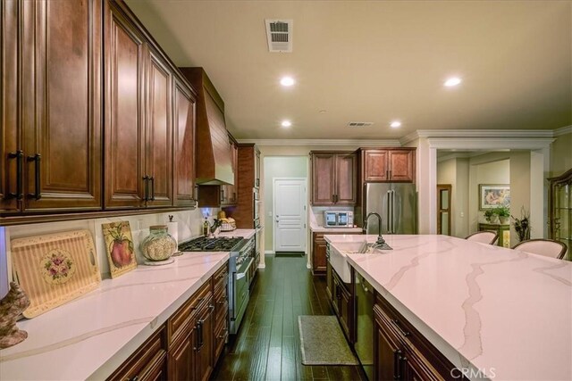 30459 Cowboy Ln, Menifee, CA 92584 - kitchen with appliances with stainless steel finishes, light stone countertops, recessed lighting, dark wood-style floors, and ornamental molding