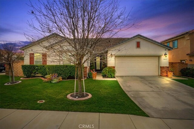 30459 Cowboy Ln, Menifee, CA 92584 - ranch-style house featuring driveway, an attached garage, a front lawn, and stucco siding