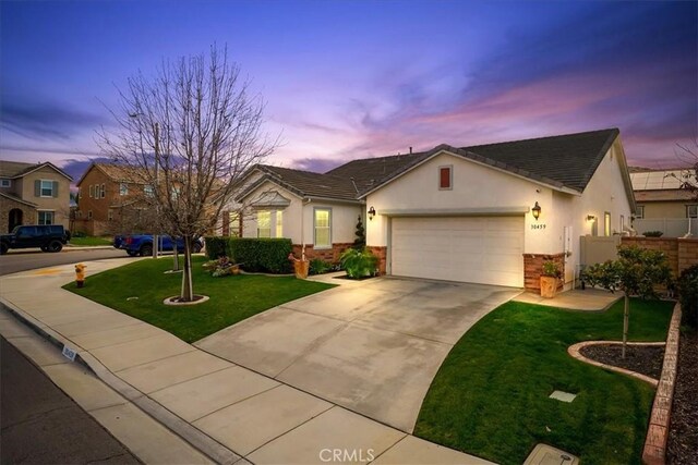 30459 Cowboy Ln, Menifee, CA 92584 - single story home with stucco siding, a garage, concrete driveway, and stone siding
