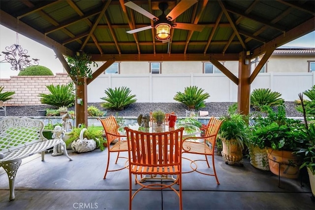 view of patio / terrace featuring a gazebo, outdoor dining area, and a fenced backyard