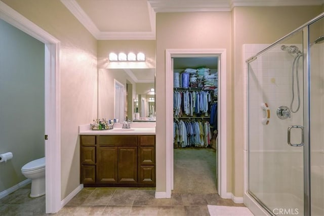 bathroom with crown molding, vanity, a shower stall, and toilet