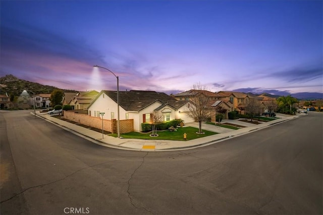 ranch-style home featuring a residential view and stucco siding