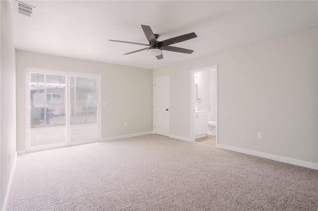 spare room featuring visible vents, baseboards, light colored carpet, and a ceiling fan