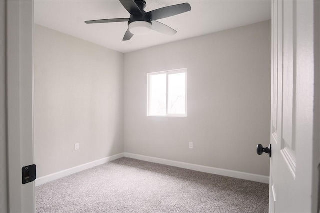 spare room featuring ceiling fan, baseboards, and carpet