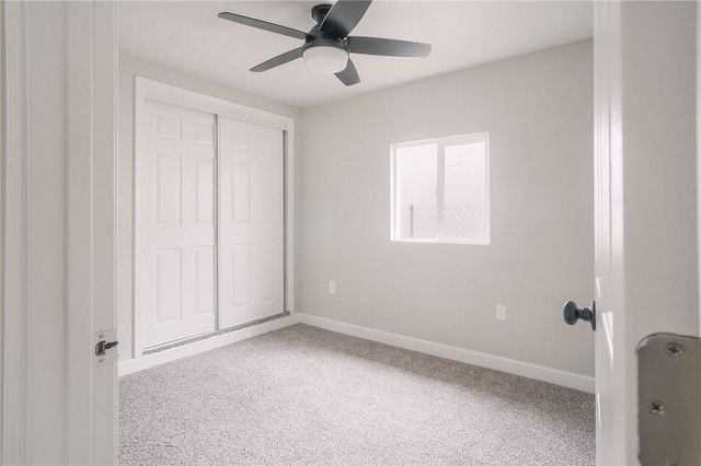 unfurnished bedroom featuring a closet, ceiling fan, baseboards, and carpet floors