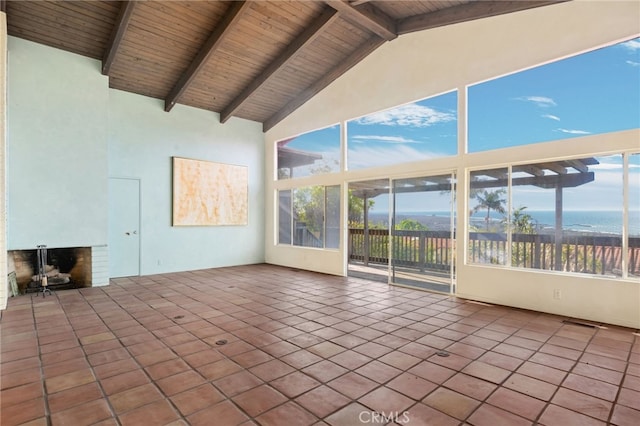 unfurnished sunroom with beamed ceiling and visible vents