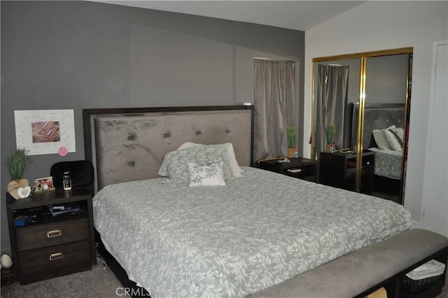 bedroom featuring a closet, carpet flooring, and vaulted ceiling