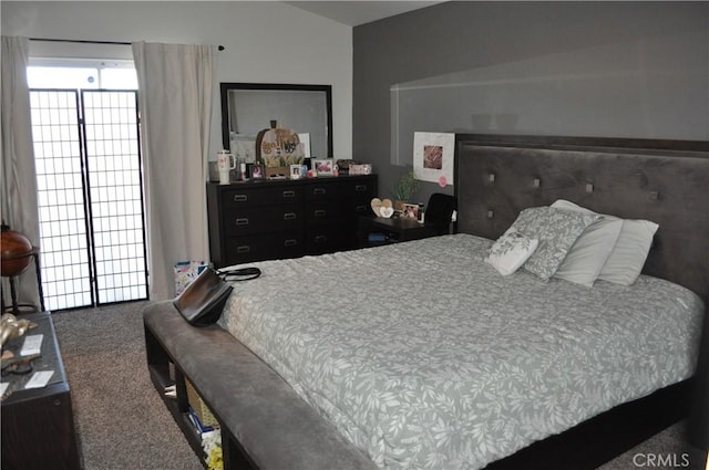 carpeted bedroom with lofted ceiling