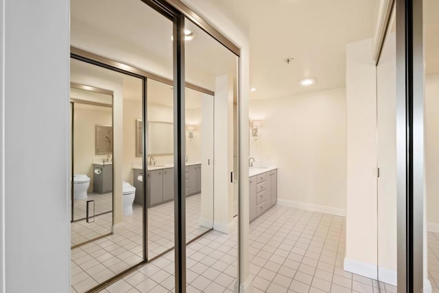 bathroom with tile patterned floors, toilet, recessed lighting, baseboards, and vanity