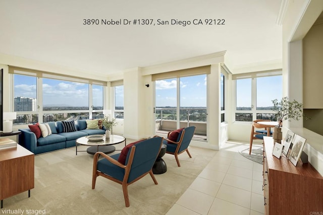 living room with crown molding, a view of city, and light tile patterned floors