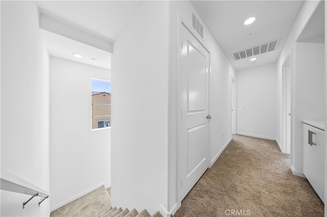 hall featuring recessed lighting, visible vents, carpet floors, and baseboards
