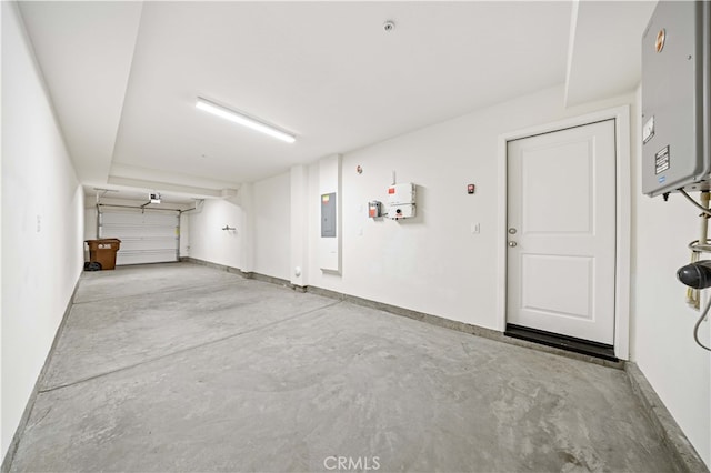 garage with electric panel, baseboards, and water heater