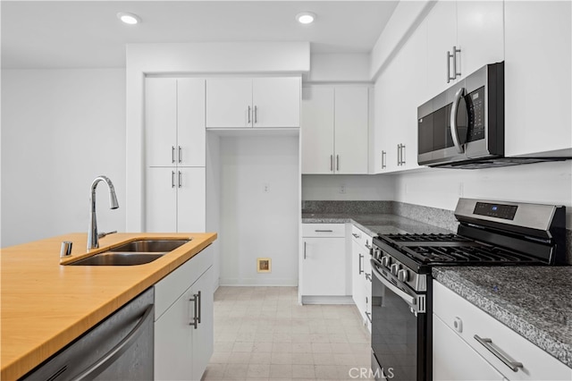 kitchen with white cabinets, recessed lighting, appliances with stainless steel finishes, and a sink