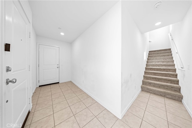 hallway featuring stairs, light tile patterned floors, recessed lighting, and baseboards