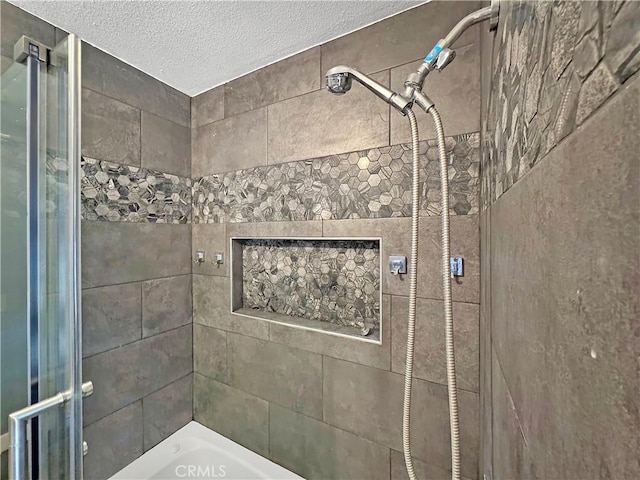 full bathroom featuring a tub, tiled shower, and a textured ceiling