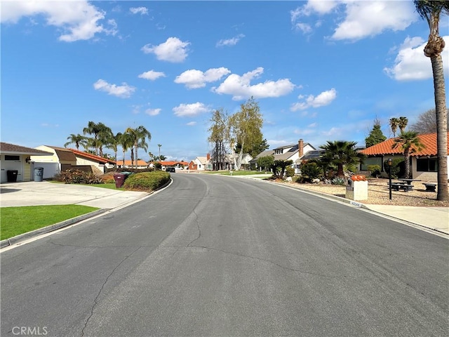 view of street featuring curbs and a residential view