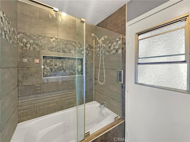 full bathroom featuring a textured ceiling and a combined bath / shower with jetted tub