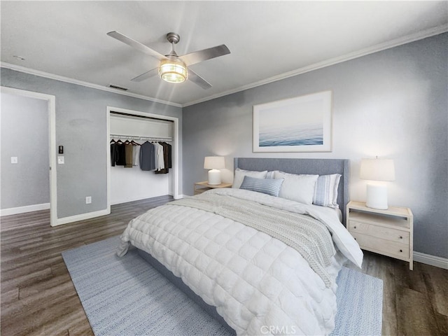 bedroom with baseboards, ornamental molding, wood finished floors, and a closet