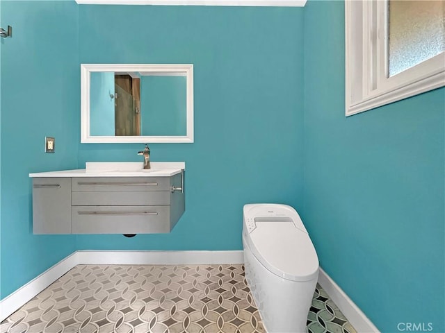 bathroom with vanity and baseboards