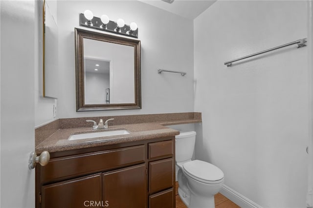 bathroom with toilet and vanity