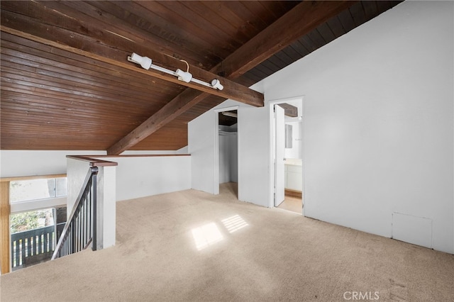 additional living space with wooden ceiling, carpet floors, and lofted ceiling with beams