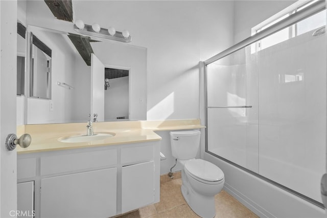 full bath featuring vanity, toilet, combined bath / shower with glass door, and tile patterned flooring