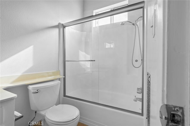 full bath with vanity, toilet, and combined bath / shower with glass door