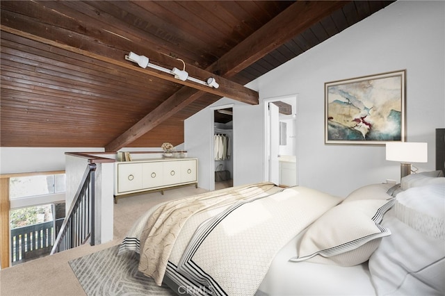 carpeted bedroom featuring a closet, lofted ceiling with beams, wood ceiling, and ensuite bathroom