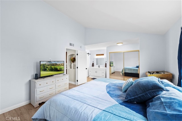 1330 Vista Grande Unit 27, Fullerton, CA 92835 - bedroom featuring light wood-style floors, baseboards, a closet, connected bathroom, and high vaulted ceiling