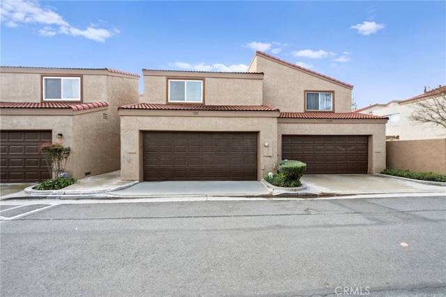 1330 Vista Grande Unit 27, Fullerton, CA 92835 - view of front of house featuring stucco siding and a garage
