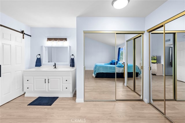 1330 Vista Grande Unit 27, Fullerton, CA 92835 - bathroom with connected bathroom, wood finished floors, healthy amount of natural light, and vanity