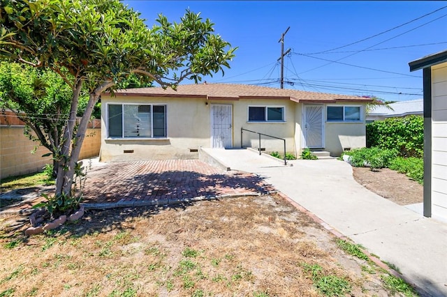 view of front of home with fence and stucco siding