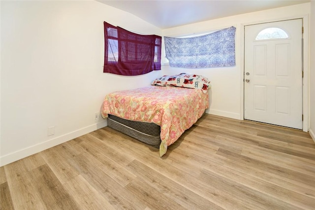 bedroom featuring wood finished floors and baseboards