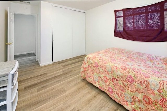 bedroom with a closet and wood finished floors