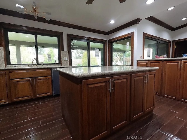 28132 Via Congora, Mission Viejo, CA 92692 - kitchen featuring ornamental molding, decorative backsplash, a kitchen island, light stone countertops, and wood tiled floor