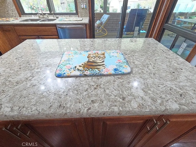 28132 Via Congora, Mission Viejo, CA 92692 - kitchen with stainless steel dishwasher, light stone countertops, brown cabinetry, and a sink